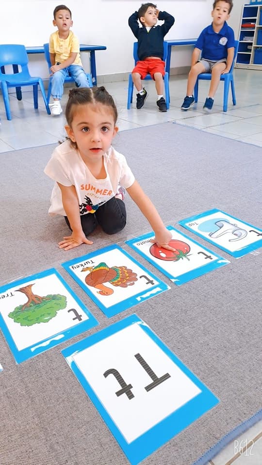 Child learning letters with flashcards